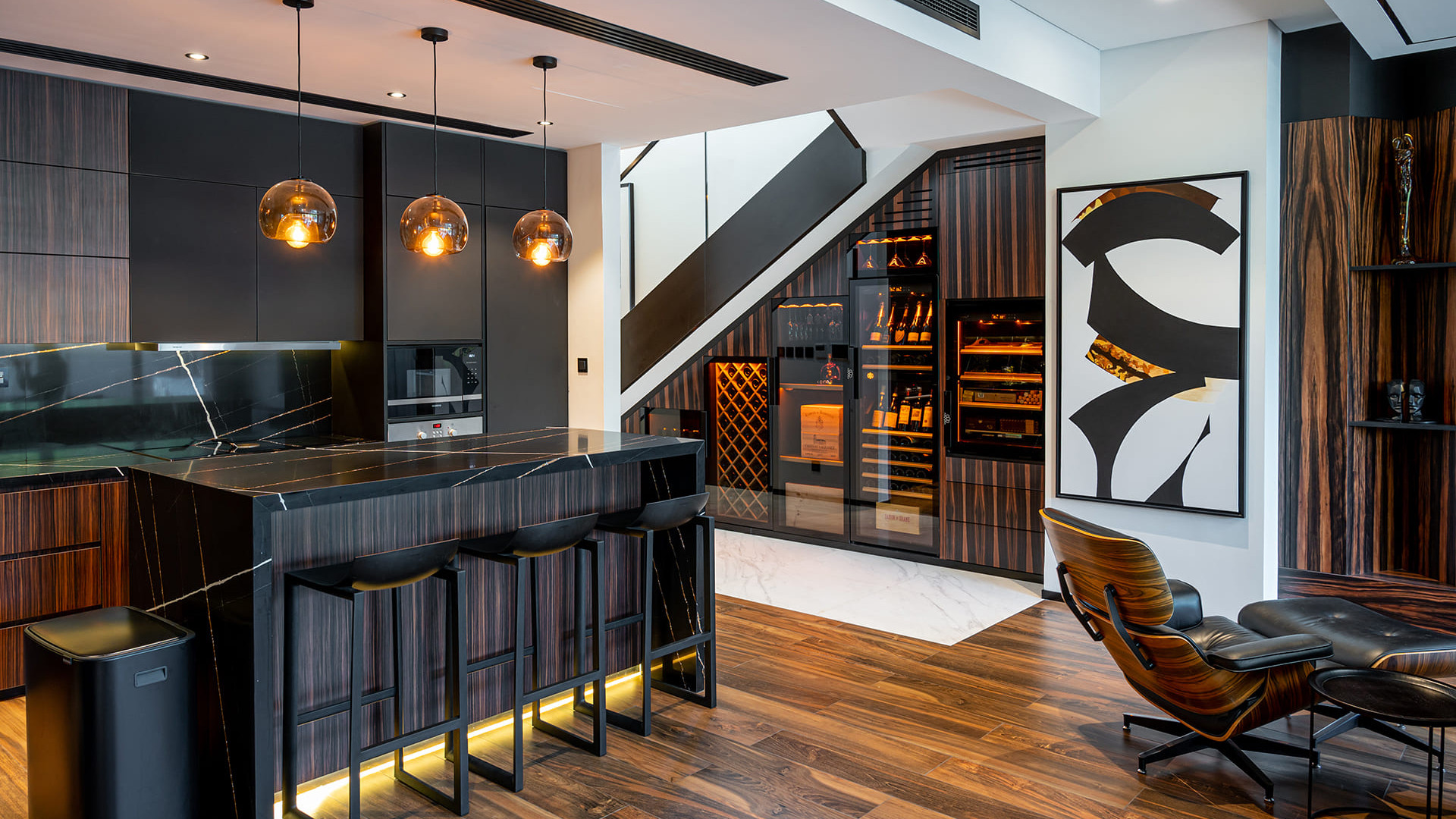 Wine and cigar home station - wall cabinet created under the stairs in an architect's apartment with high-end interior decoration.