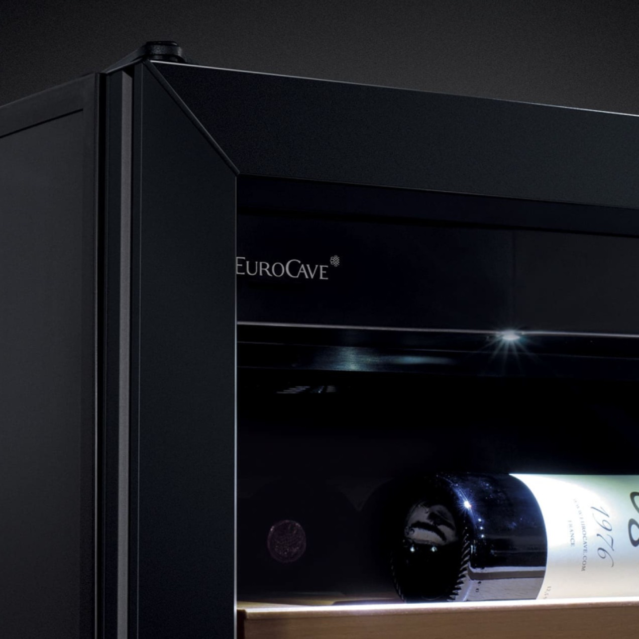 Enhancement of wine bottles in the cooler with white interior lighting.