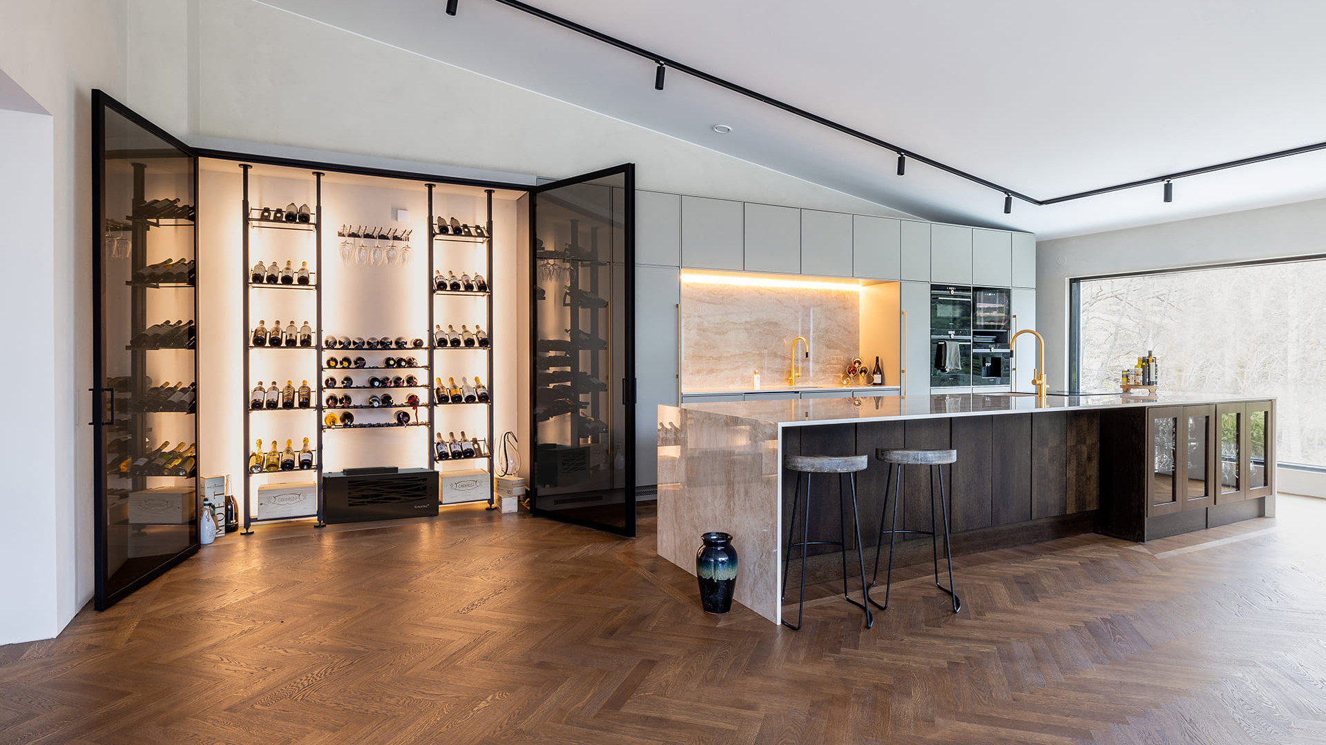 Custom air-conditioned wine area. Example of making a glass wall display case in a luxury kitchen. Elegant interior architecture. Custom air-conditioned wine area. Example of making a glass wall display case in a luxury kitchen. Elegant interior architecture.