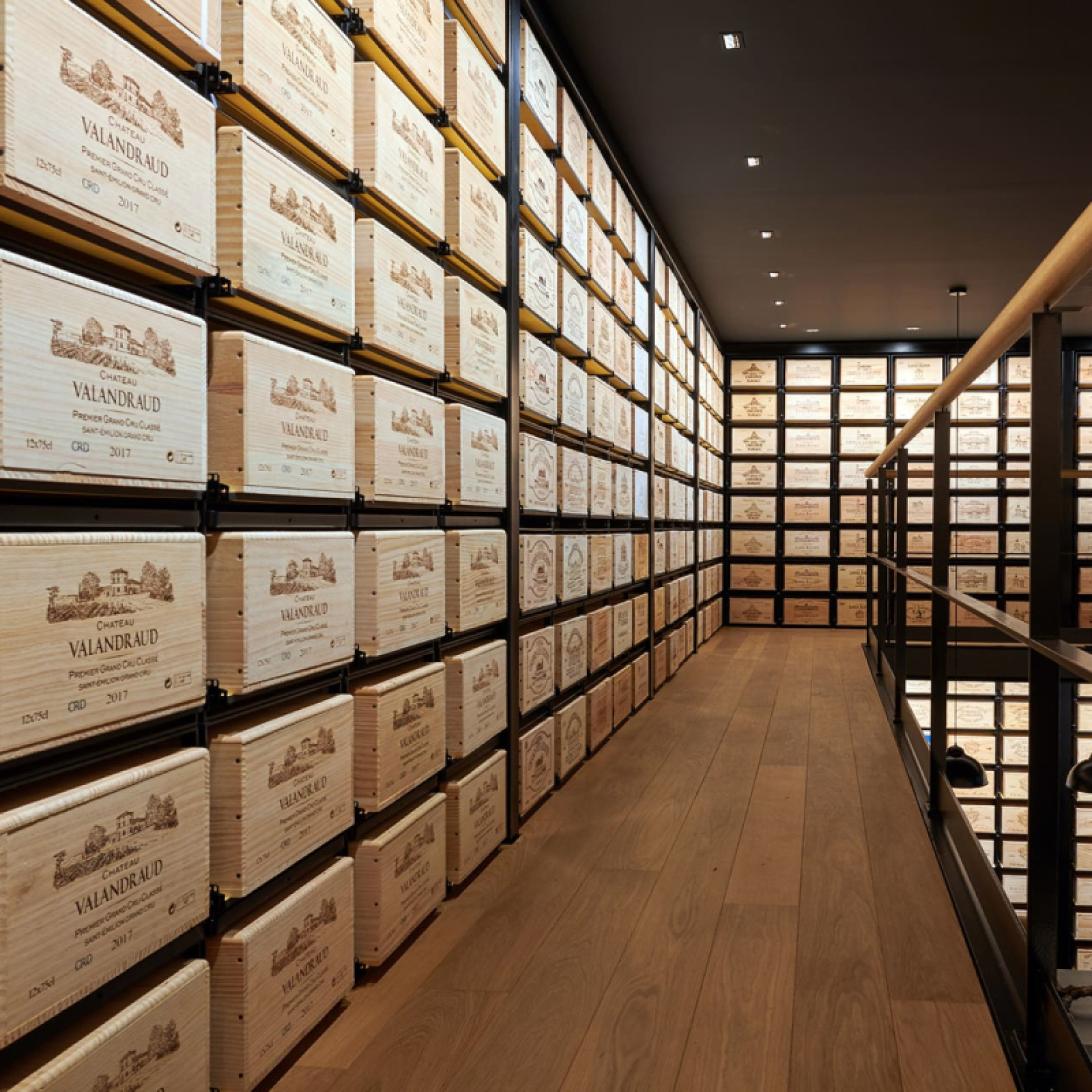 Wine wall created with sliding wine racks for easy access to your wine cases.