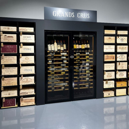 Layout and scenarisation of a wine section in a wine shop by EuroCave Annecy - Modulorack professional sliding and collapsible wine storage furniture and 2 Revelation glass wine fridges fitted into a made-to-measure cabinet.