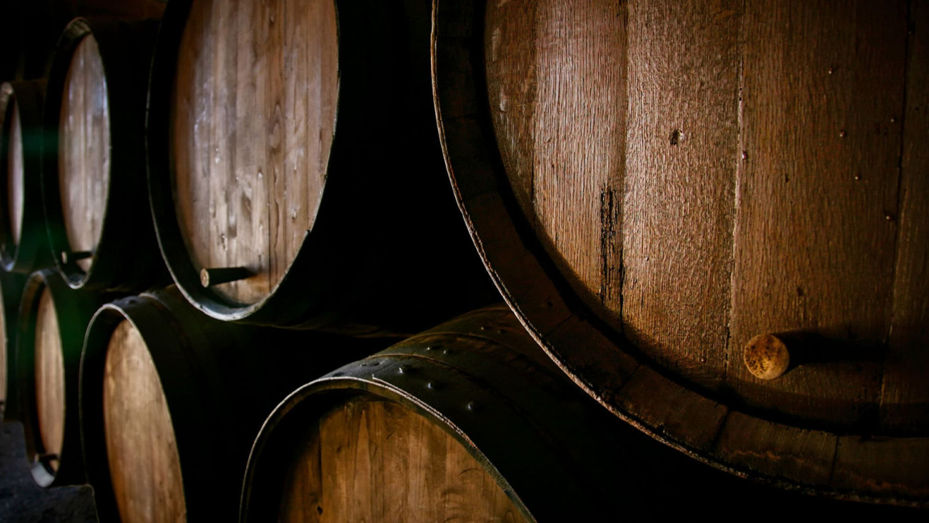 Photo of barrels where wine is aged in the winemaker’s cellar before bottling. Photo of barrels where wine is aged in the winemaker’s cellar before bottling.