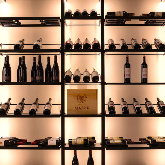 Wine room display. Modular metal structure with integrated lighting for an elegant showcase of wine bottles. Wine room display. Modular metal structure with integrated lighting for an elegant showcase of wine bottles.