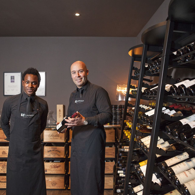 Tasting room with sommelier advising a client. Professional wine cellar design. Wine racks for wine shops and restaurants. Tasting room with sommelier advising a client. Professional wine cellar design. Wine racks for wine shops and restaurants.