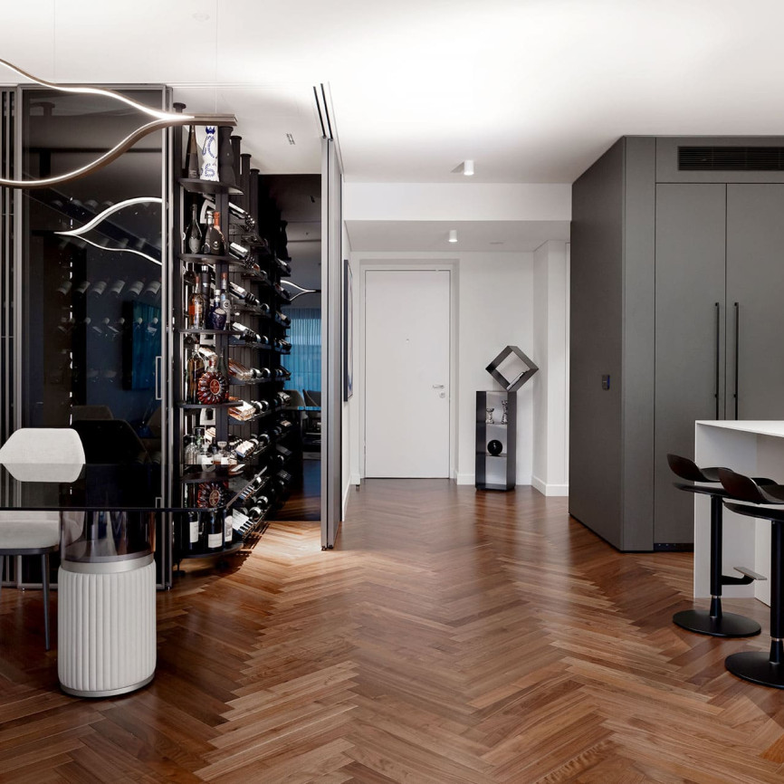 Glazed and air-conditioned wine cellar showcase in a dining room with open kitchen in a luxury flat. Modulo-X EuroCave metal wine storage unit Glazed and air-conditioned wine cellar showcase in a dining room with open kitchen in a luxury flat. Modulo-X EuroCave metal wine storage unit