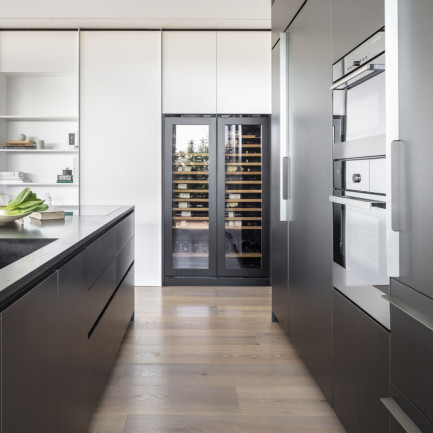Double wine ageing fridge with technical glass doors, integrated into a custom kitchen - EuroCave Inspiration