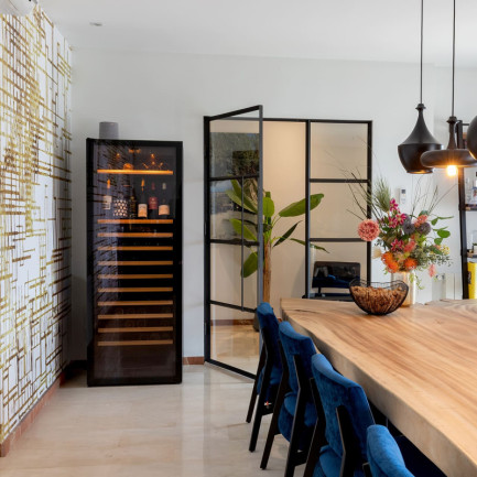 Pure wine aeging fridge with bottles displayed freestanding in a living room