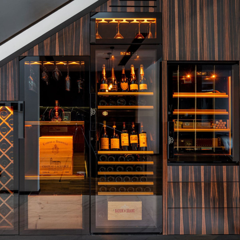 High-end service wine wall installation with integrated EuroCave Pure wine coolers and cigar cellar in Dubai.