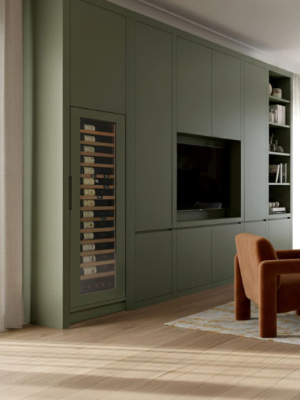 Large EuroCave wine cooler with technical glass door and integrated lighting, built into a custom olive-colored contemporary cabinet, integrated into an elegant living space