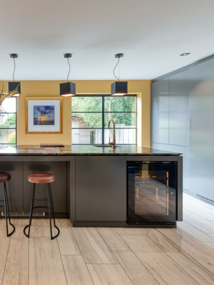 Small Inspiration collection wine cooler with glass door built under counter in a contemporary kitchen island, seamlessly integrated into cabinetry, elegant and functional design