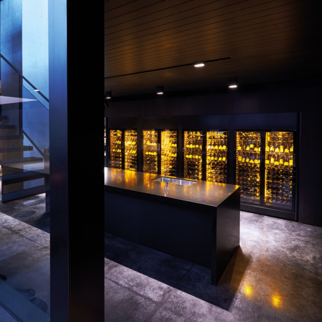 Multiple EuroCave ShowCave wine coolers forming a wine wall with amber lighting - single temperature - wine storage and serving temperature control