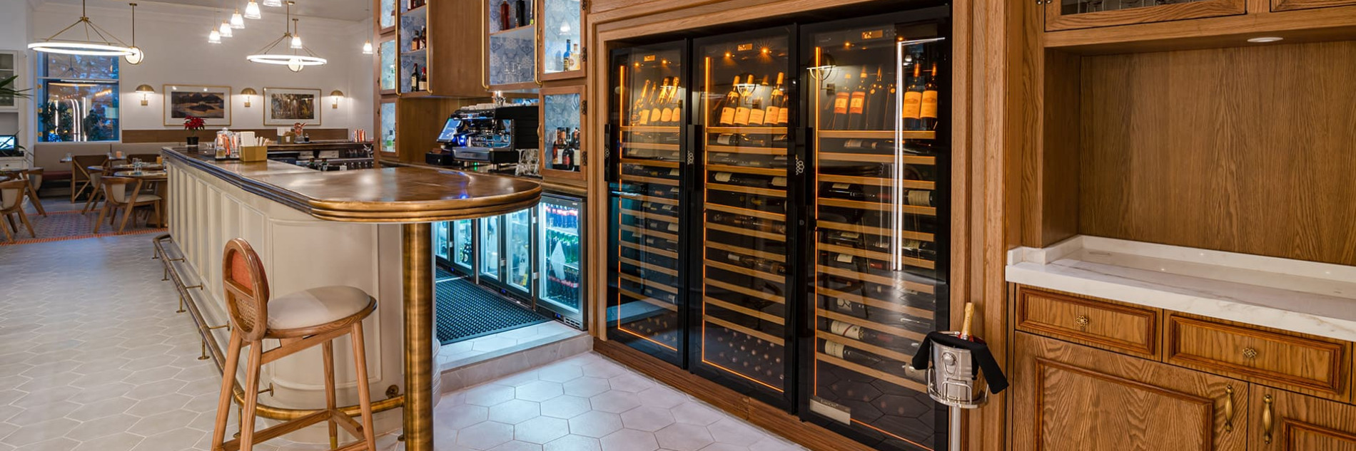 Restaurant featuring a wine wall made up of three EuroCave wine cabinets.