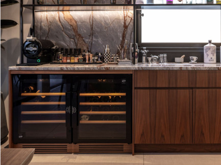 EuroCave Compact range: two wine cabinets installed side-by-side under a bar, featuring a marble finish and a spirits section.