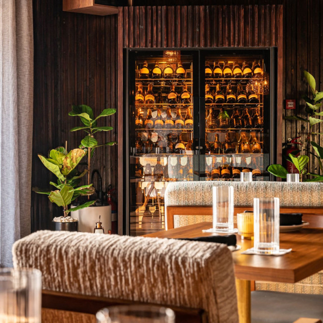 Refrigerated wine showcase installed in a restaurant dining room – bottles kept at serving temperature – The Nice Guy Restaurant, Dubai