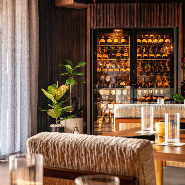 Refrigerated wine showcase installed in a restaurant dining room – bottles kept at serving temperature – The Nice Guy Restaurant, Dubai